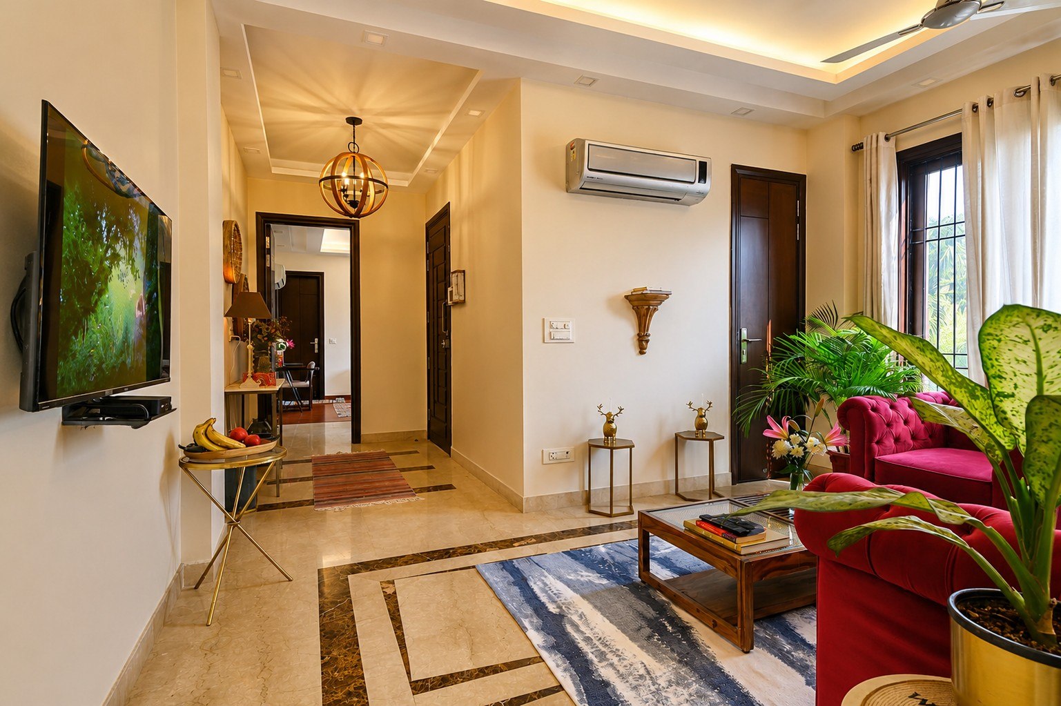 Open living and arrival view with seating, television, and doorway context.