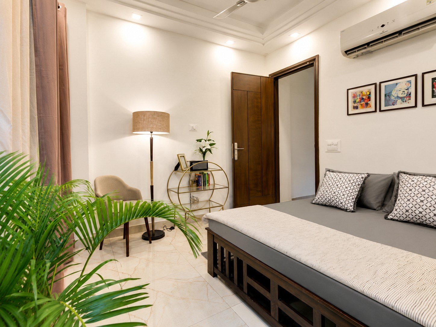 Sleeping space with bedside lighting and a wall-mounted air conditioner.