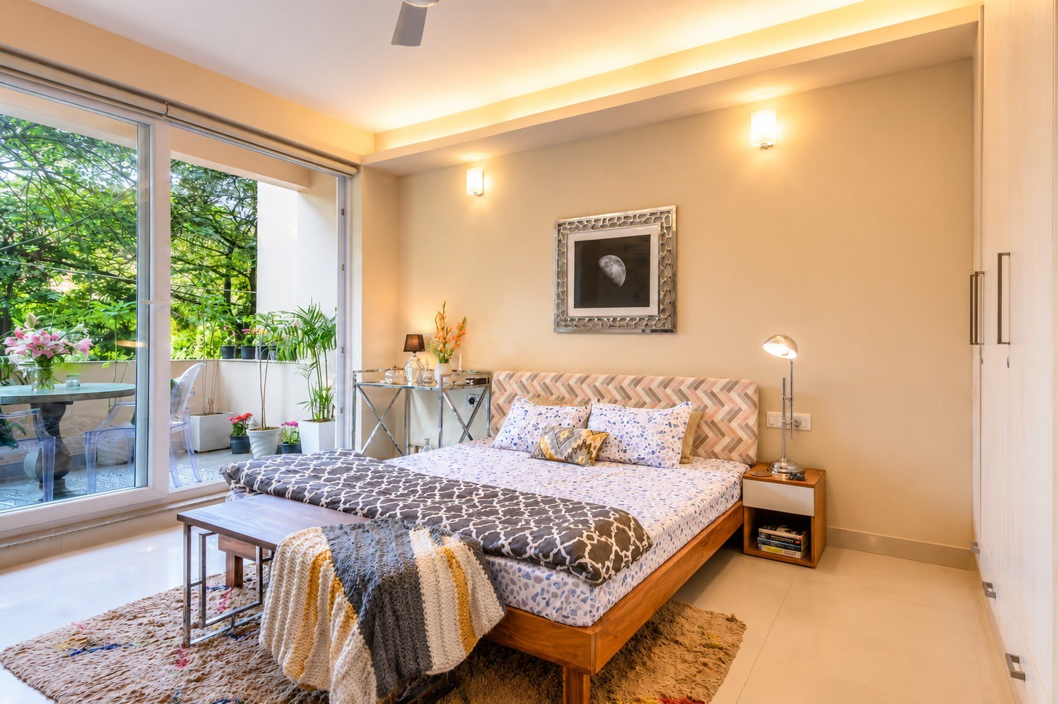 Bedroom opening toward a broad green-facing window or balcony.