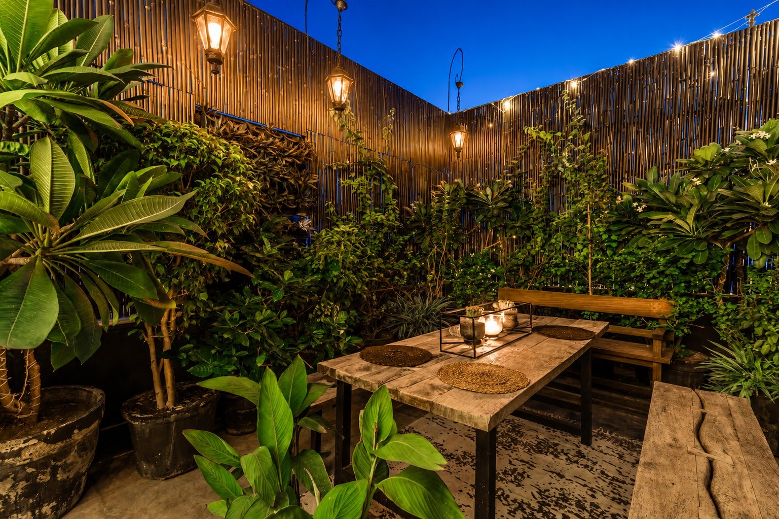 Evening terrace seating and garden setting with plants and lighting.