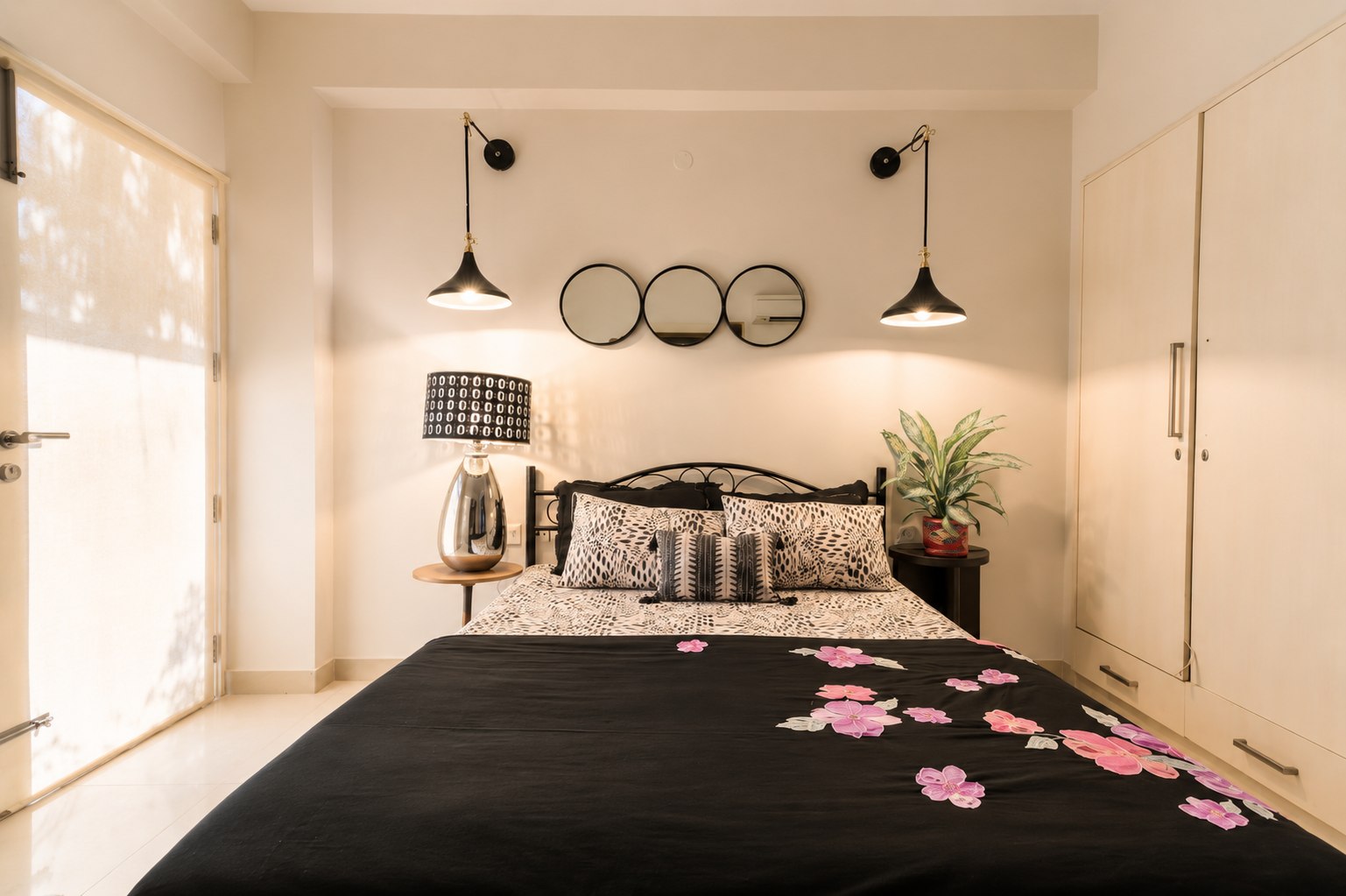 Additional sleeping space with different bedding and pendant lighting.