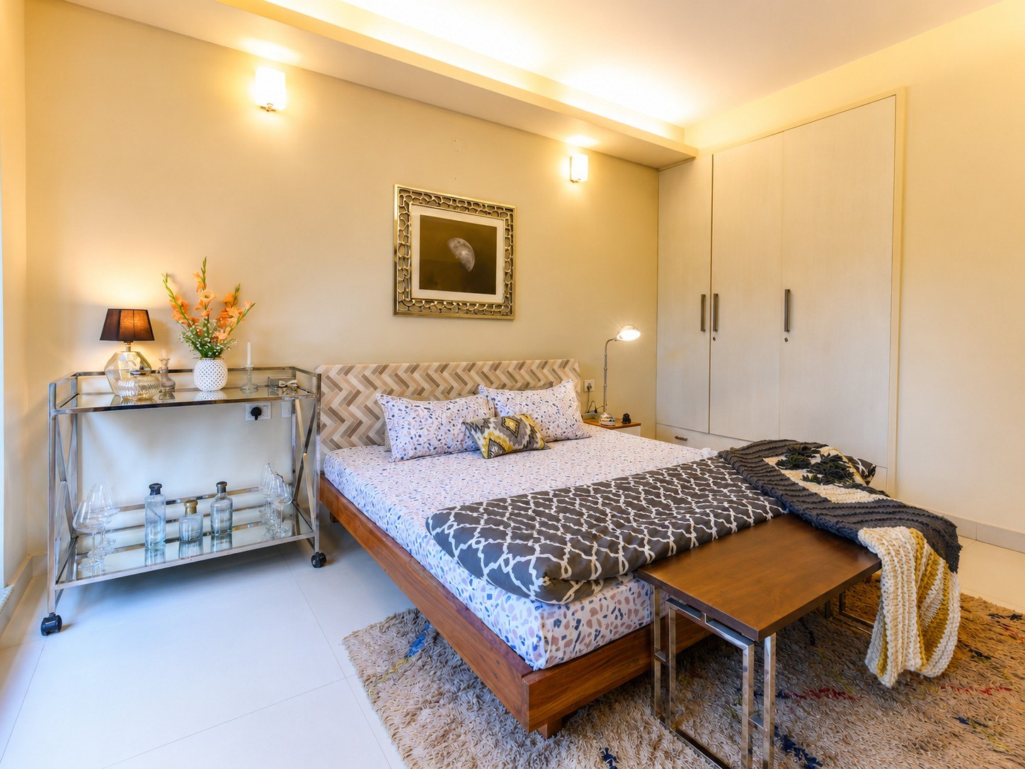 Alternate view of a bedroom with artwork and bedside tables.