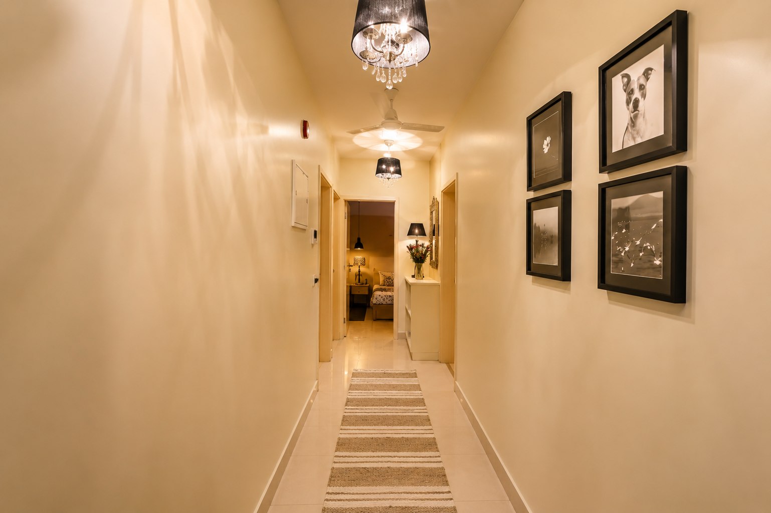 Hallway with framed artwork and a calm arrival path through the home.