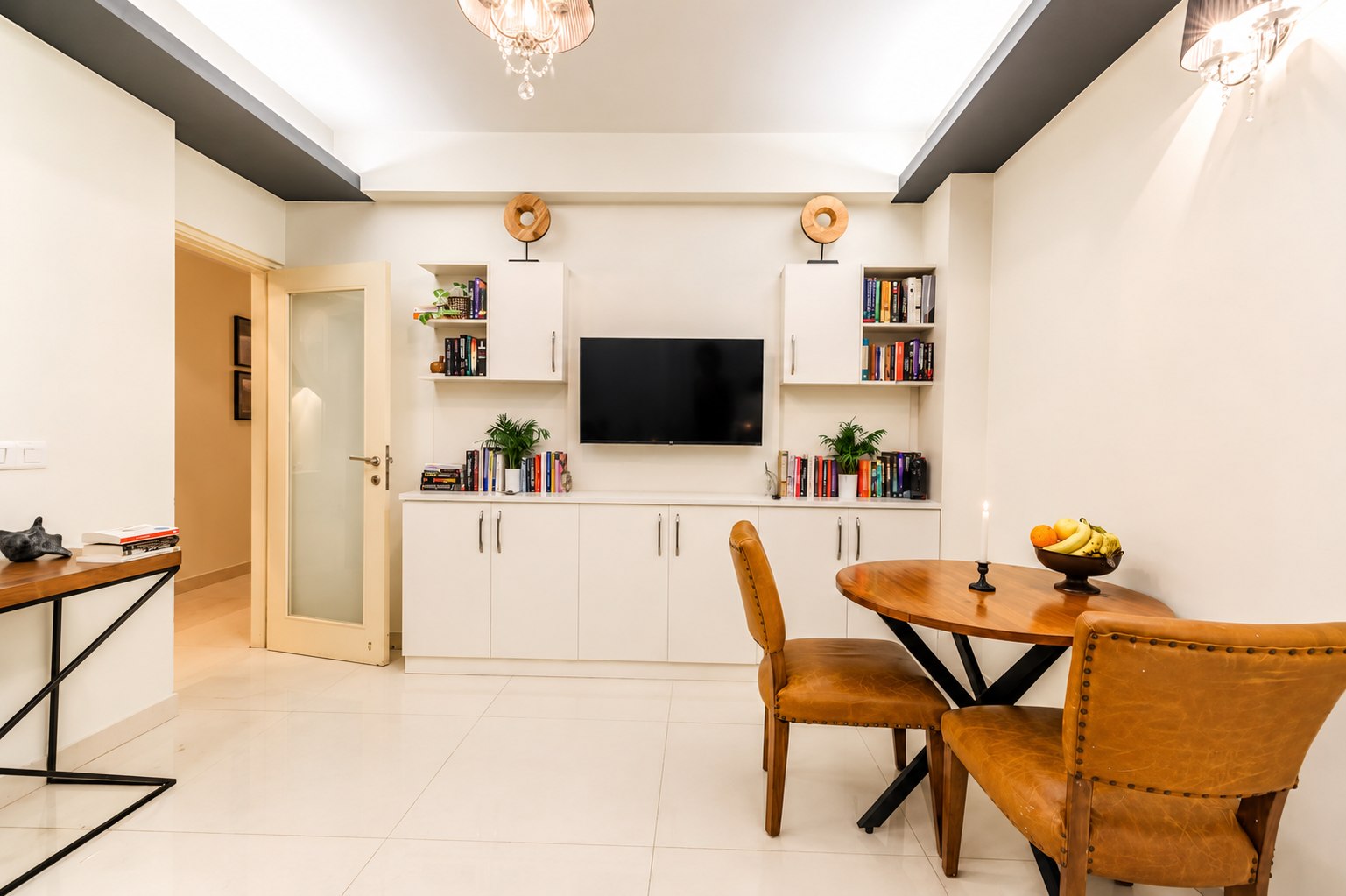 Dining area with table, chairs, and built-in storage.