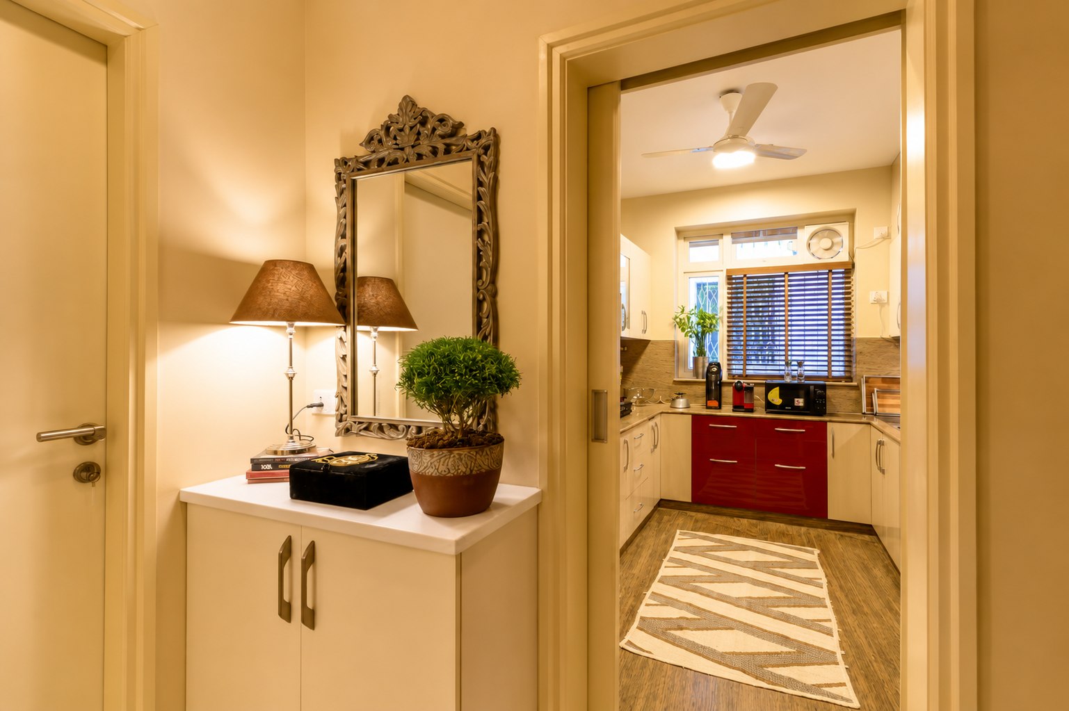 Hallway view with a glimpse toward the kitchen and home interior.